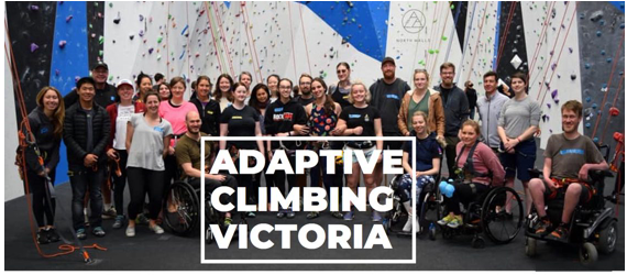 Pictured are many people standing together for a photo. Some people are standing, others are in wheelchairs. Inthe background is a climbing call and ropes. In front of the image are the words, adaptive climbing Victoria 